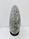 Side view of silver mosaic donut lamp showing fiberglass base