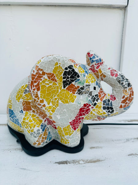Mosaic elephant lamp side view switched off on white background, displaying vibrant rainbow glass mosaic.