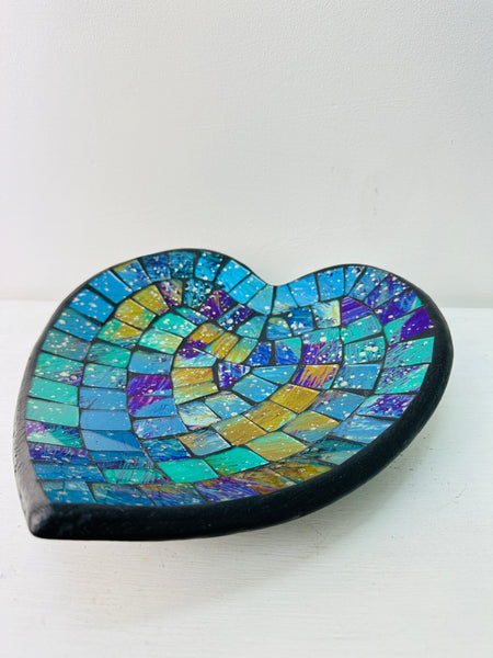 op view of handmade mosaic heart bowl showing vibrant cyan, turquoise and green glass mosaic pieces on black rim.