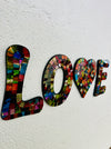 side view of mosaic love letters on white background