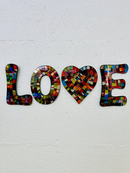 front view of mosaic 'love' letters on white background