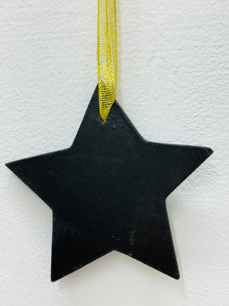 Back of red mosaic star showing black MDF backing and gold mesh ribbon.