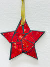 Red mosaic glass star ornament with gold mesh ribbon, front view.
