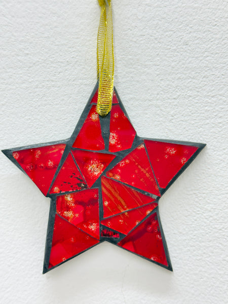 Red mosaic glass star ornament with gold mesh ribbon, front view.