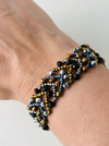 Beaded bracelet on a wrist with a neutral background