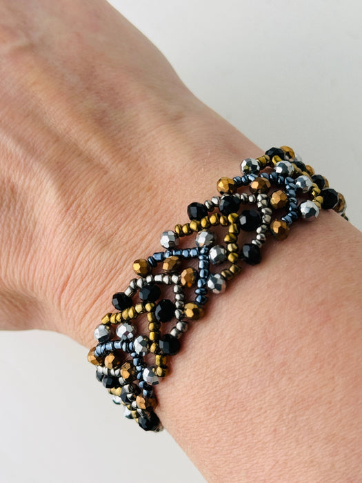 Beaded bracelet on a wrist with a neutral background