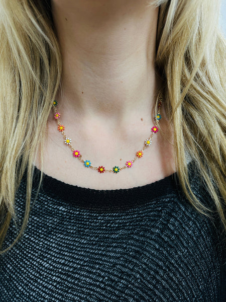 delicate necklace with small multicolour enamel flower charms on a fine chain on a model
