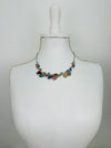 Multicoloured teardrop shaped enamel statement necklace with silver-tone chain, displayed on a mannequin.