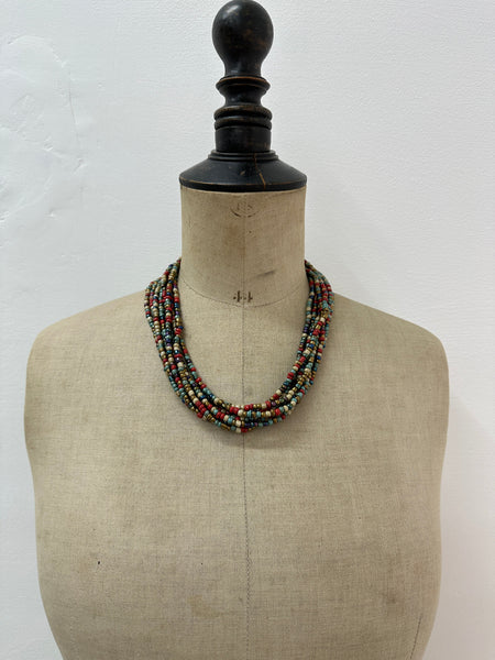 Multicolored beaded necklace on a mannequin 