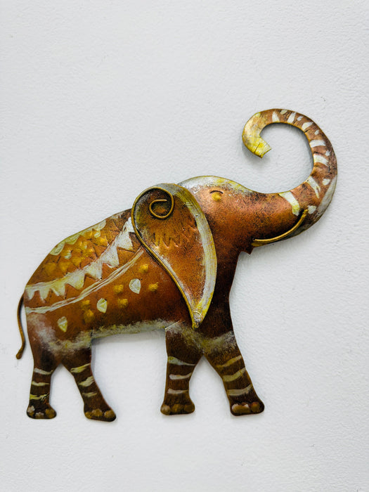 Large hand-painted metal elephant wall sculpture with gold, copper and silver detailing