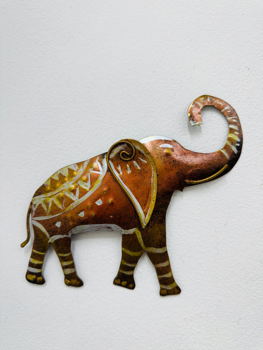 Medium hand-painted metal elephant wall sculpture with gold and silver detailing