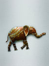 Small hand-painted metal elephant wall sculpture with gold and silver detailing on white background