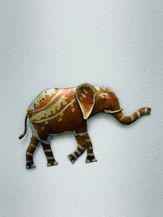 Small hand-painted metal elephant wall sculpture with gold and silver detailing on white background