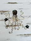 Back of green octopus metal wall art showing hanging eyelet and metal structure