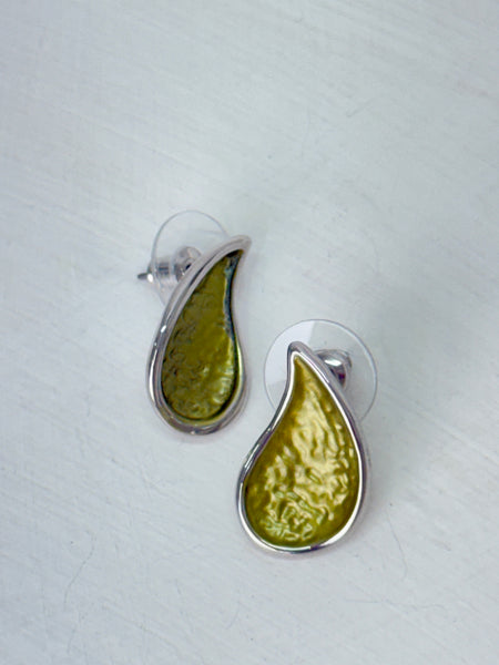 Olive green teardrop enamel stud earrings with silver tone, displayed on a white table.