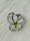 Simple silver open petal flower ring with gold centre, displayed on a white background.
