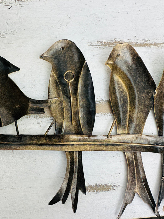 Back view of metal parakeet wall art showing hidden eyelet mounting rings