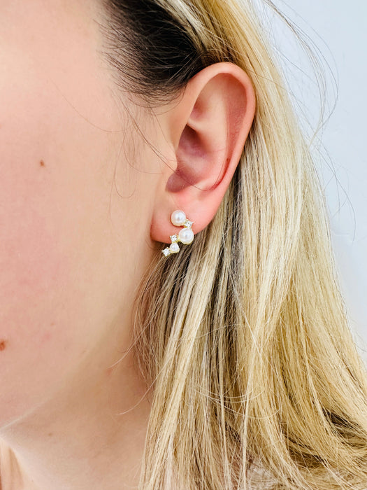 Close-up of an ear wearing a pearl earring 