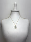 gold necklace with floral face silhouette pendant