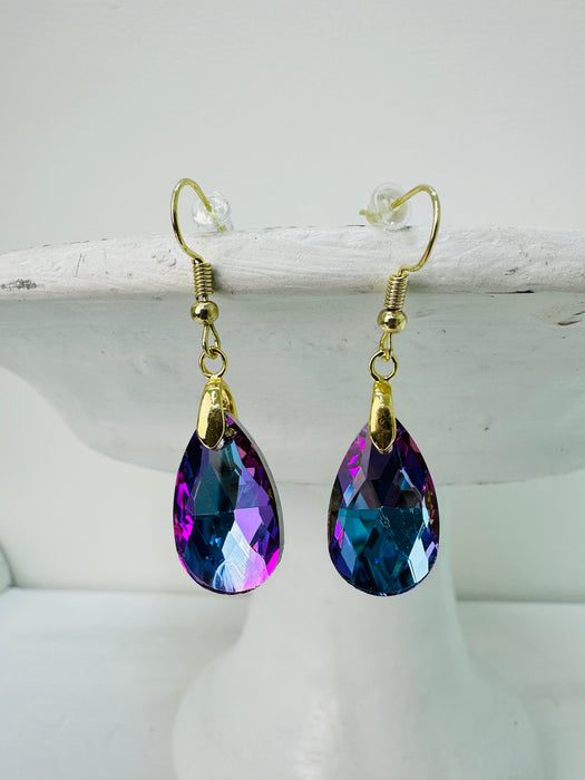 A pair of purple teardrop earrings with gold-colored hooks, displayed against a white background.