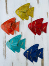Assorted colourful metal rainbow fish wall art displayed together in multiple colours