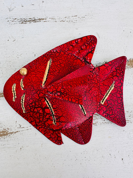 Front view of hand-painted red metal fish showing mottled paint and gold accents