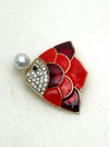 red enamel fish brooch with crystal details and pearl on white background