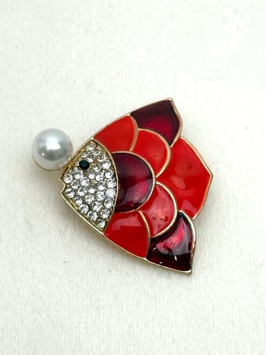 red enamel fish brooch with crystal details and pearl on white background