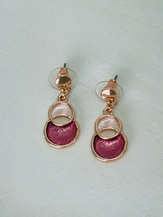 Rose-gold drop earrings with circular design.