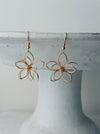 close-up of delicate flower wire earrings