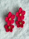 rose red flower-shaped hair clips on a white textured background