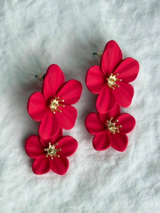 rose red flower-shaped hair clips on a white textured background