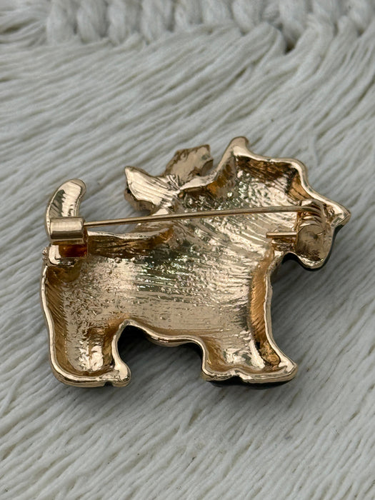 back of brooch on a textured gray background