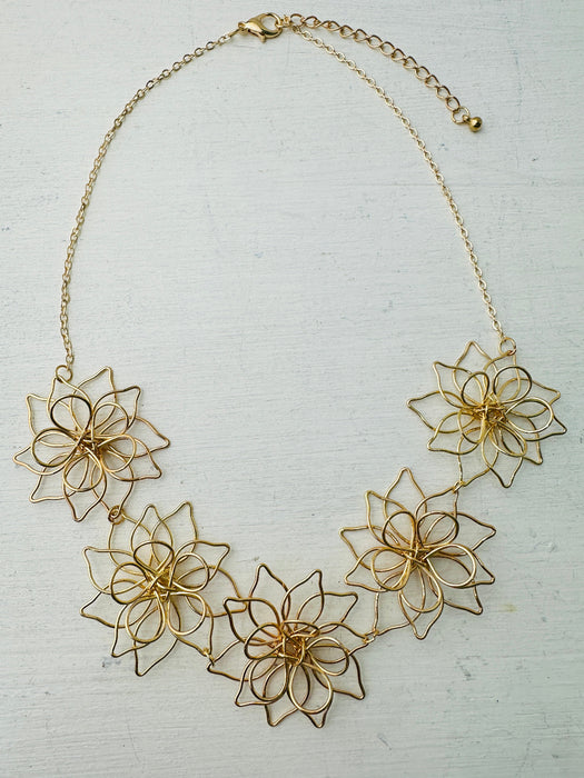 front of gold flower link necklace