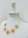 side angle of gold flower necklace