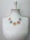 Necklace with floral designs on a mannequin bust 