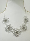 close-up of short silver flower link necklace