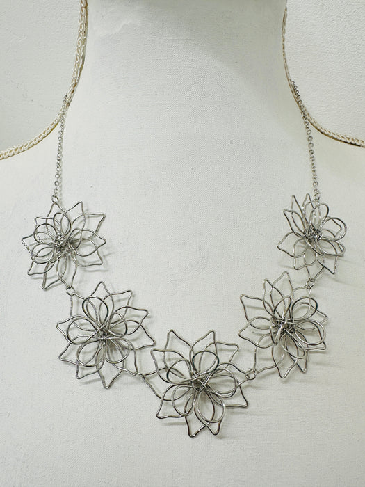 close-up of short silver flower link necklace
