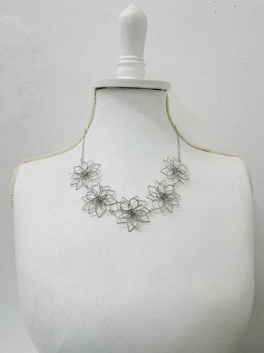short silver flower link necklace displayed on a mannequin