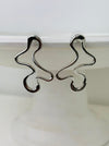 close-up of abstract silver earrings
