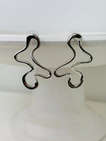 close-up of abstract silver earrings