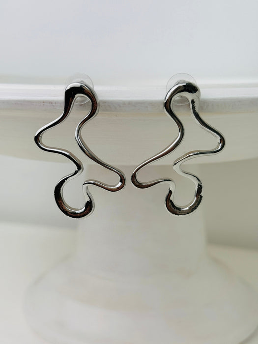 close-up of abstract silver earrings