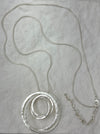 silver necklace with layered textured circle pendants