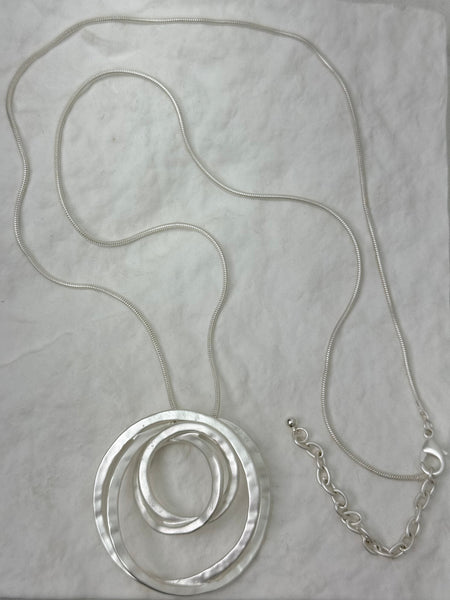 silver necklace with layered textured circle pendants