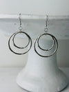 close-up of silver double hoop dangle earrings