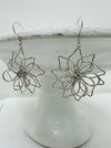 close-up of silver wire dangle earrings