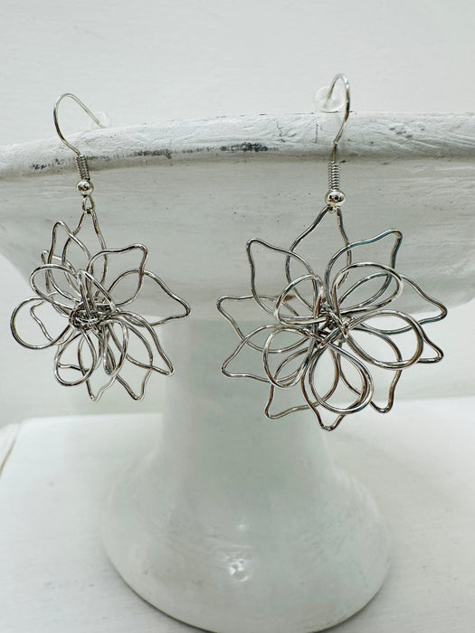 close-up of silver wire dangle earrings