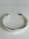 Silver bracelet on a light gray background