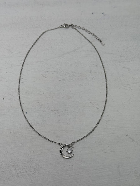silver necklace with crescent moon an star pendant dainty celestial design.