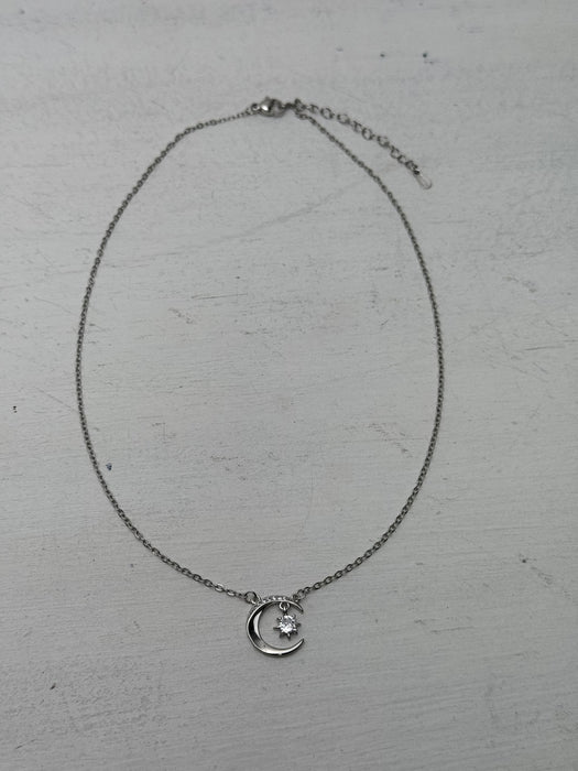 silver necklace with crescent moon an star pendant dainty celestial design.